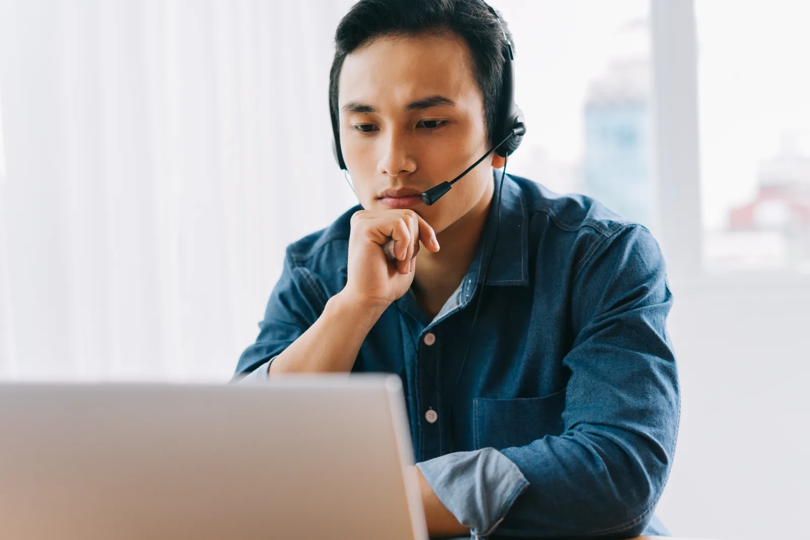 Roctec technical support engineer on a headset assisting a client